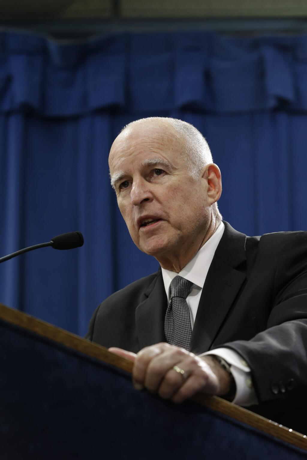 In this Jan. 9, 2015 photo, Gov. Jerry Brown discusses his proposed 2015-2016 state budget plan which includes a proposal to deal with the unfunded liability for the state employee health care retirement benefits at during Capitol news conference in Sacramento, Calif. Brown said that he wants to negotiate with state workers to start chipping in half of the cost of their benefits to bring down the estimated $72 billion unfunded liability.(AP Photo/Rich Pedroncelli)