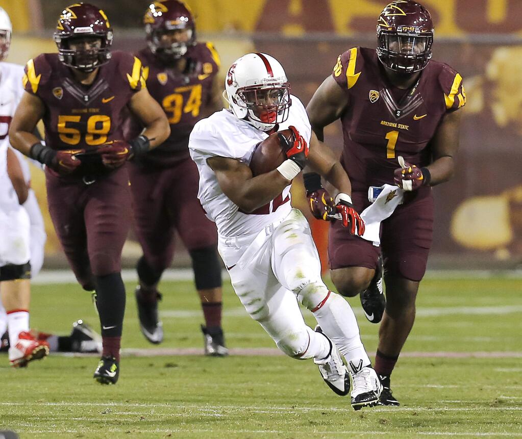 Stanford running back Remound Wright (22) runs for a first down against Arizona State during the second half of the NCAA college football game, Saturday, Oct. 18, 2014, in Tempe, Ariz. (AP Photo/Rick Scuteri)