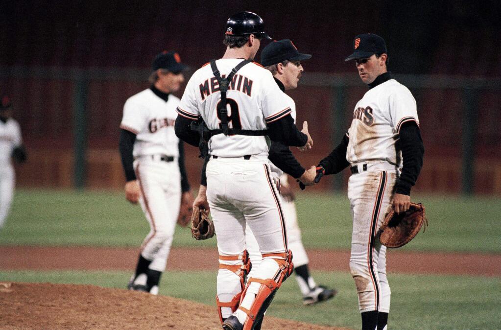San Francisco Giants' players Bob Melvin, left, Craig Lefferts, center, and Will Clark, right, congratulate one another after their 6-3 win over the Cincinnati Reds at Candlestick Park, Sept. 28, 1988. (AP Photo/Annie Wells)