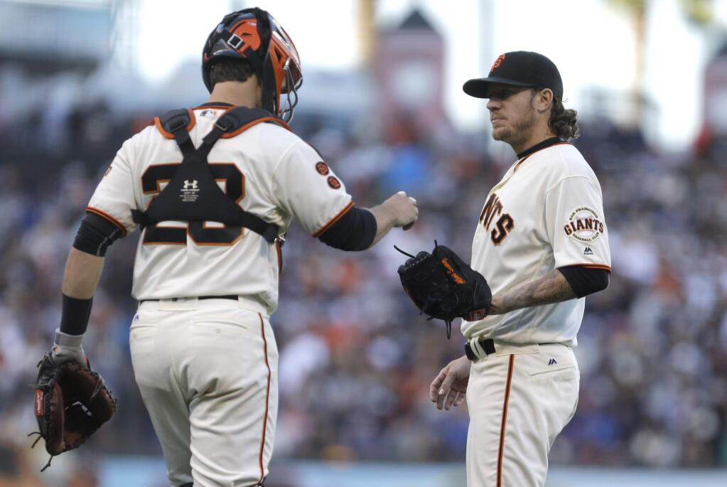 San Francisco Giants' Jake Peavy, right, speaks with catcher Buster Posey during a baseball game Sunday, June 12, 2016, in San Francisco. (AP Photo/Ben Margot)