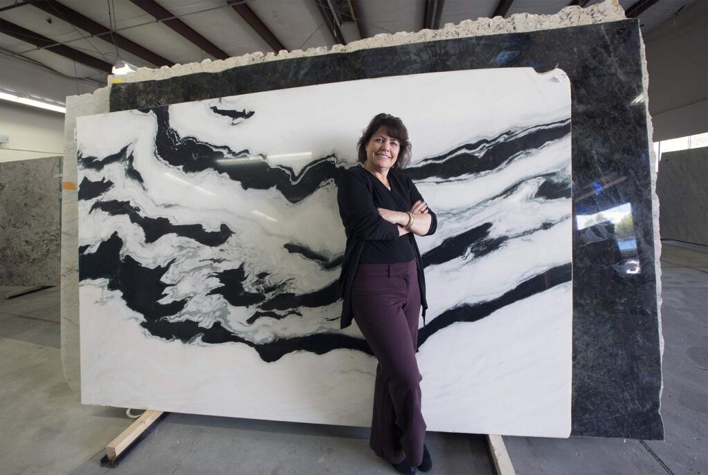 Sonoma Floor Gallery has expanded. Lisa Raffo, co-owner of the business, stands next to a marble slab known as Panda. The new warehouse on 8th St. East stocks many different stone slabs for kitchens and bathrooms. (Photos by Robbi Pengelly/Index-Tribune)