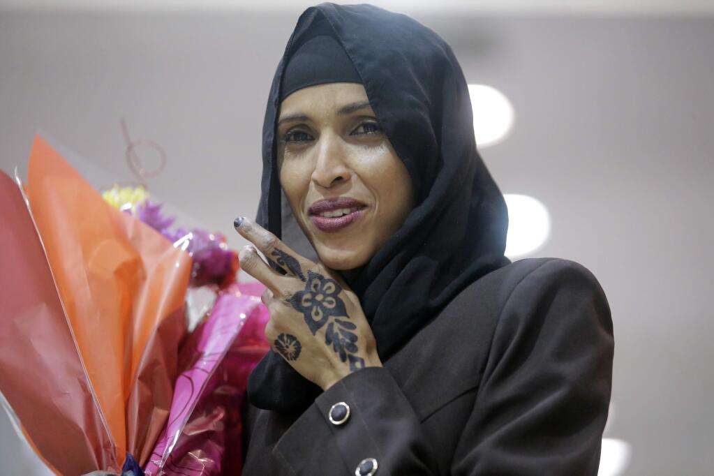 Nimo Hashi, the wife of Abdisellam Hassen Ahmed, a Somali refugee who had been stuck in limbo after President Donald Trump temporarily banned refugee entries, looks on after his arrival at Salt Lake International Airport, Friday, Feb. 10, 2017, in Salt Lake City. (AP Photo/Rick Bowmer)