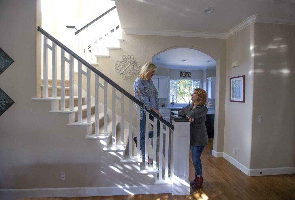 Terra Firma Global Partners Real estate agent Laura Hall, right, talks with client Melissa Nagle in her Skyhawk home in Santa Rosa that had been on the market for 34 days. ( John Burgess/The Press Democrat, 2018)