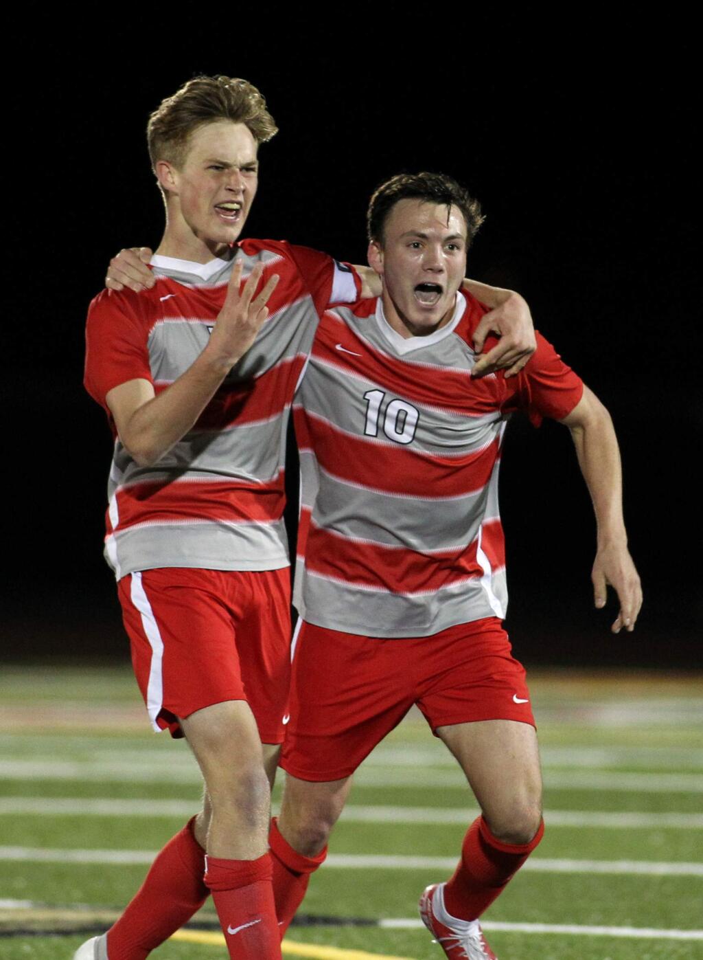 Montgomery’s Kevin Welch, left, and Zack Batchelder celebrate victory at the end of their NCS soccer championship contest against Berkeley in February. (Darryl Bush / For The Press Democrat)