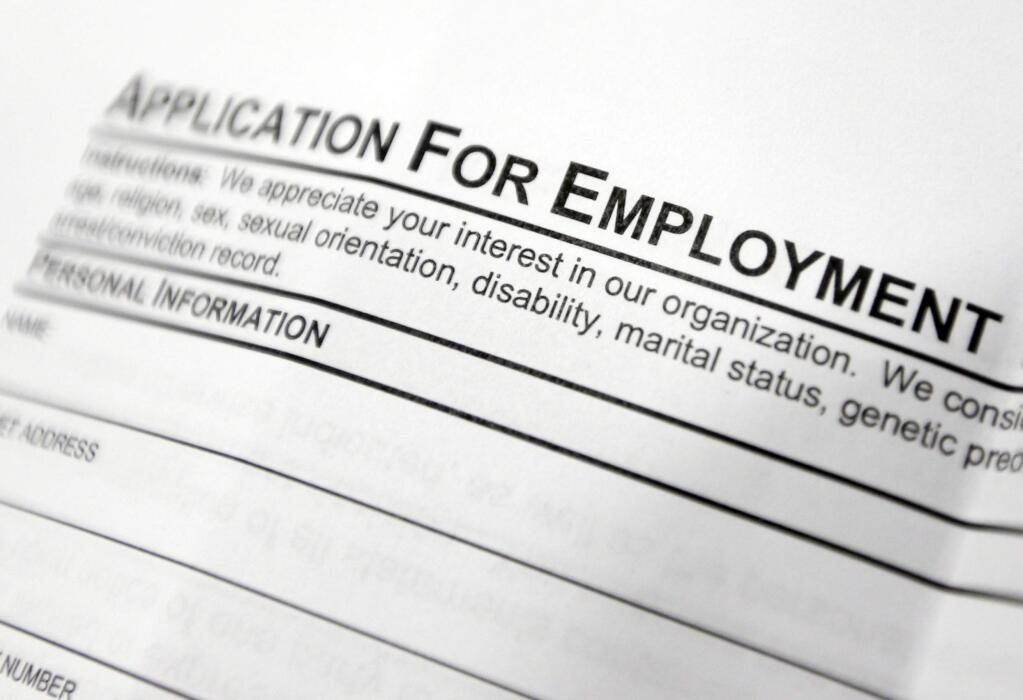 FILE - This April 22, 2014, file photo shows an employment application form on a table at a job fair in Hudson, N.Y. (AP Photo/Mike Groll, File)