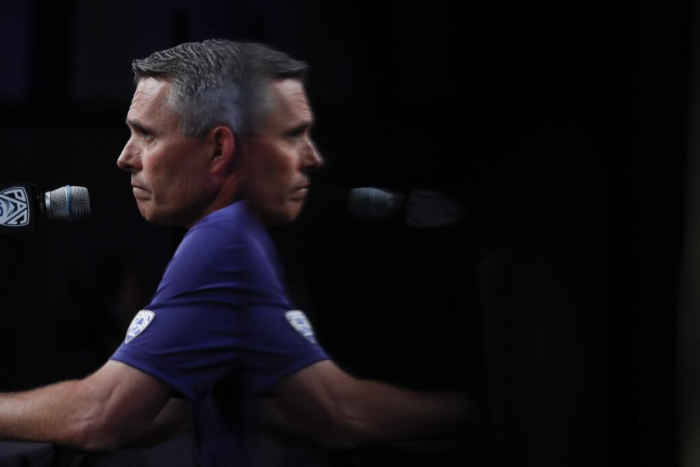 Washington head coach Chris Petersen is reflected on a screen as he speaks at the Pac-12 media day in Los Angeles, Wednesday, July 25, 2018. (AP Photo/Jae C. Hong)