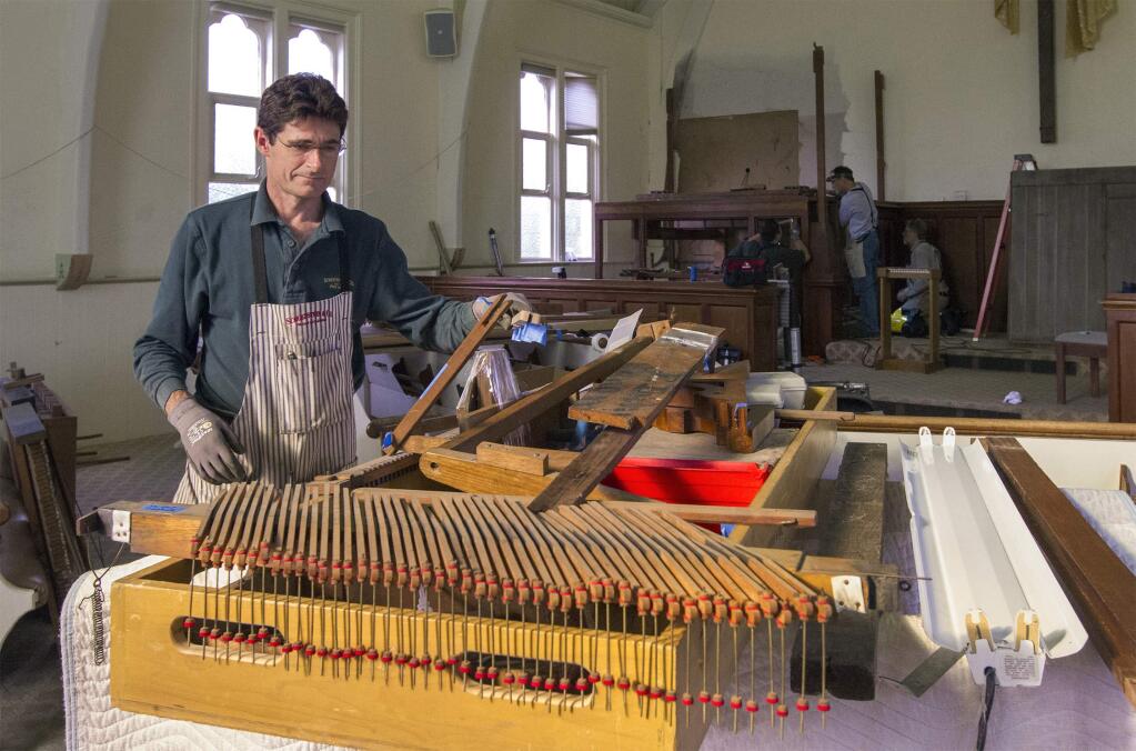 Chet Spencer, from Schowenstein & Co., is one of the professionals dismantling the organ at the First Congregational Church of Sonoma. The instrument will be cleaned, repaired and installed at the chapel at Jacuzzi Winery.