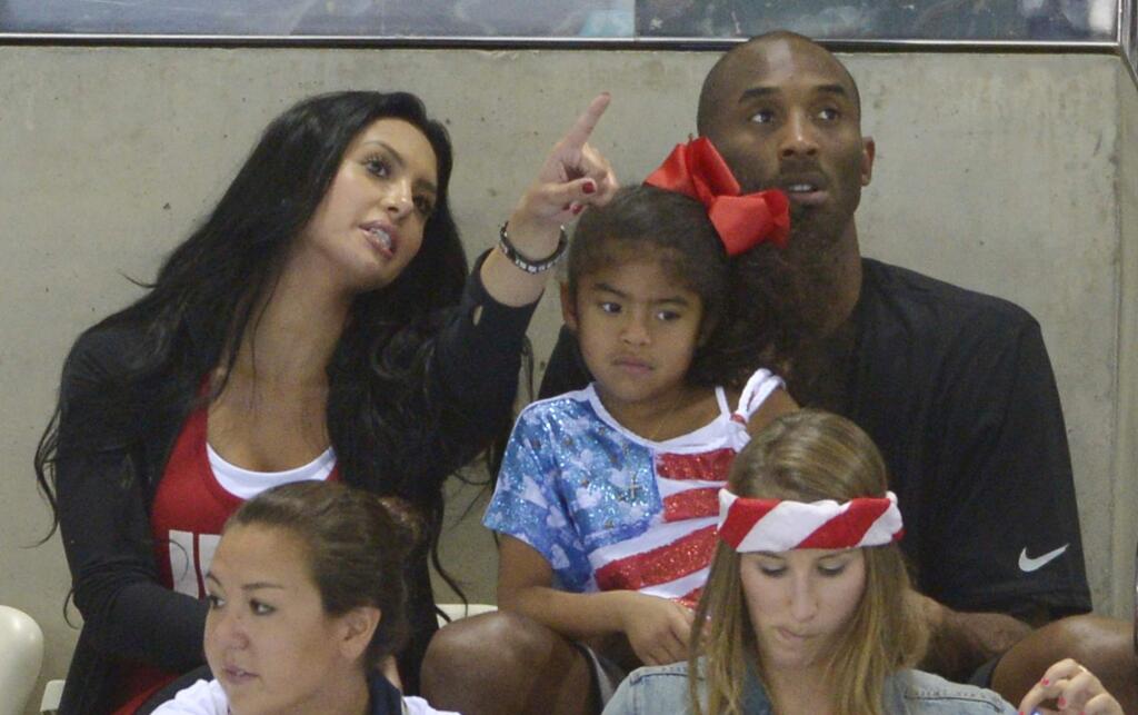 FILE - In this Aug. 4, 2012 file photo Kobe Bryant with his wife Vanessa and daughter Gianna prepare to watch the final night of swimming at the Aquatics Centre in the Olympic Park during the 2012 Summer Olympics in London. Vanessa Bryant expressed grief and anger in an Instagram post Monday, Feb. 10, 2020, as she copes with the deaths of her husband Kobe Bryant, their daughter Gigi and seven other people in a helicopter crash last month. (AP Photo/Mark J. Terrill,File)