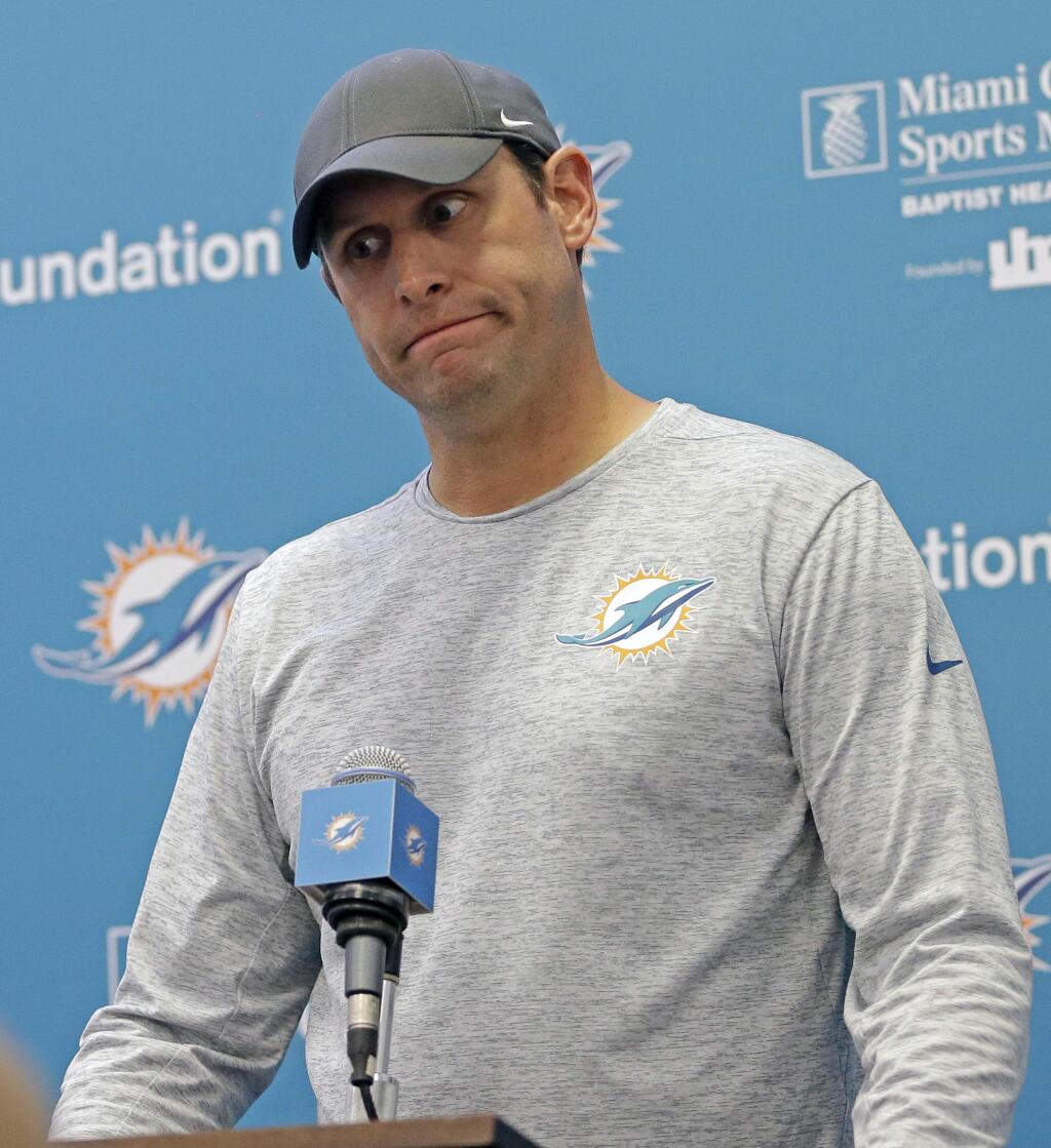 Miami Dolphins head coach Adam Gase talks to reporters during a news conference, Monday, Oct. 9, 2017, in Davie, Fla. Oct. 7, 2017. Gase says he learned hours after the team's latest game about a video on social media that appeared to show offensive line coach Chris Foerster snorting three lines of a white powdery substance at a desk. Gase says he can't describe his reaction, but says Foerster apologized to him before resigning Monday. (AP Photo/Alan Diaz)
