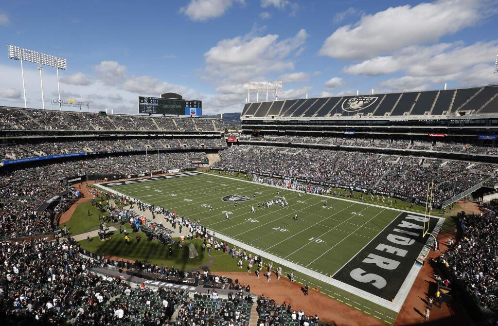FILE - In this Oct. 28, 2018, file photo, fans watch during the first half of an NFL football game between the Oakland Raiders and the Indianapolis Colts at Oakland Alameda County Coliseum in Oakland, Calif. The Coliseum Authority approved a lease agreement on Friday, March 15, 2019, to keep the Raiders in Oakland for at least one more season. (AP Photo/D. Ross Cameron, File)
