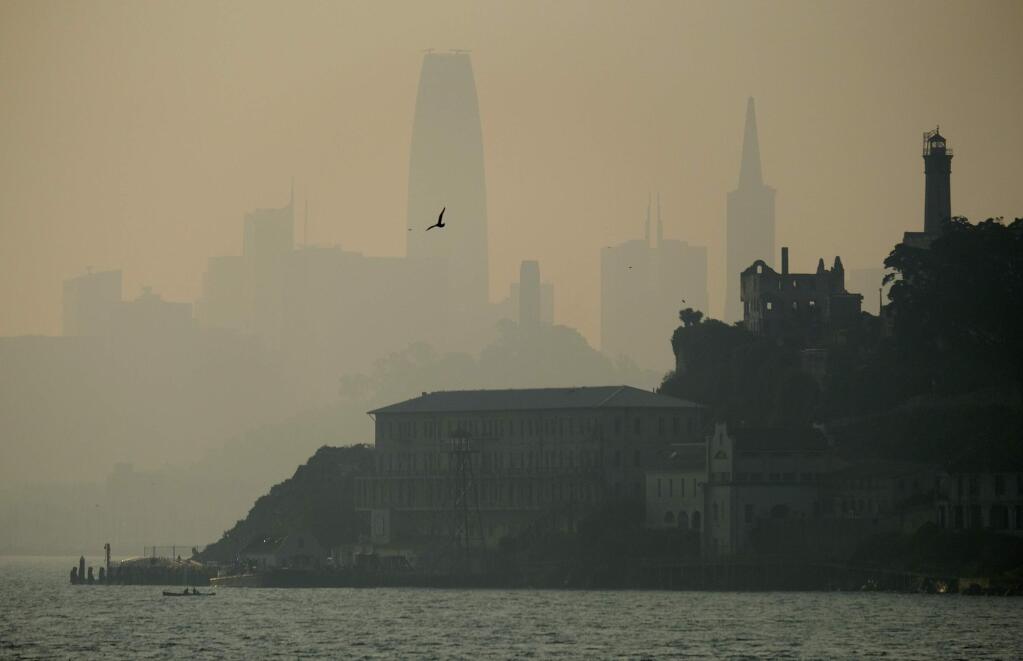 The San Francisco skyline is obscured by smoke and haze from wildfires behind Alcatraz Island Wednesday, Nov. 14, 2018, in San Francisco. (AP Photo/Eric Risberg)