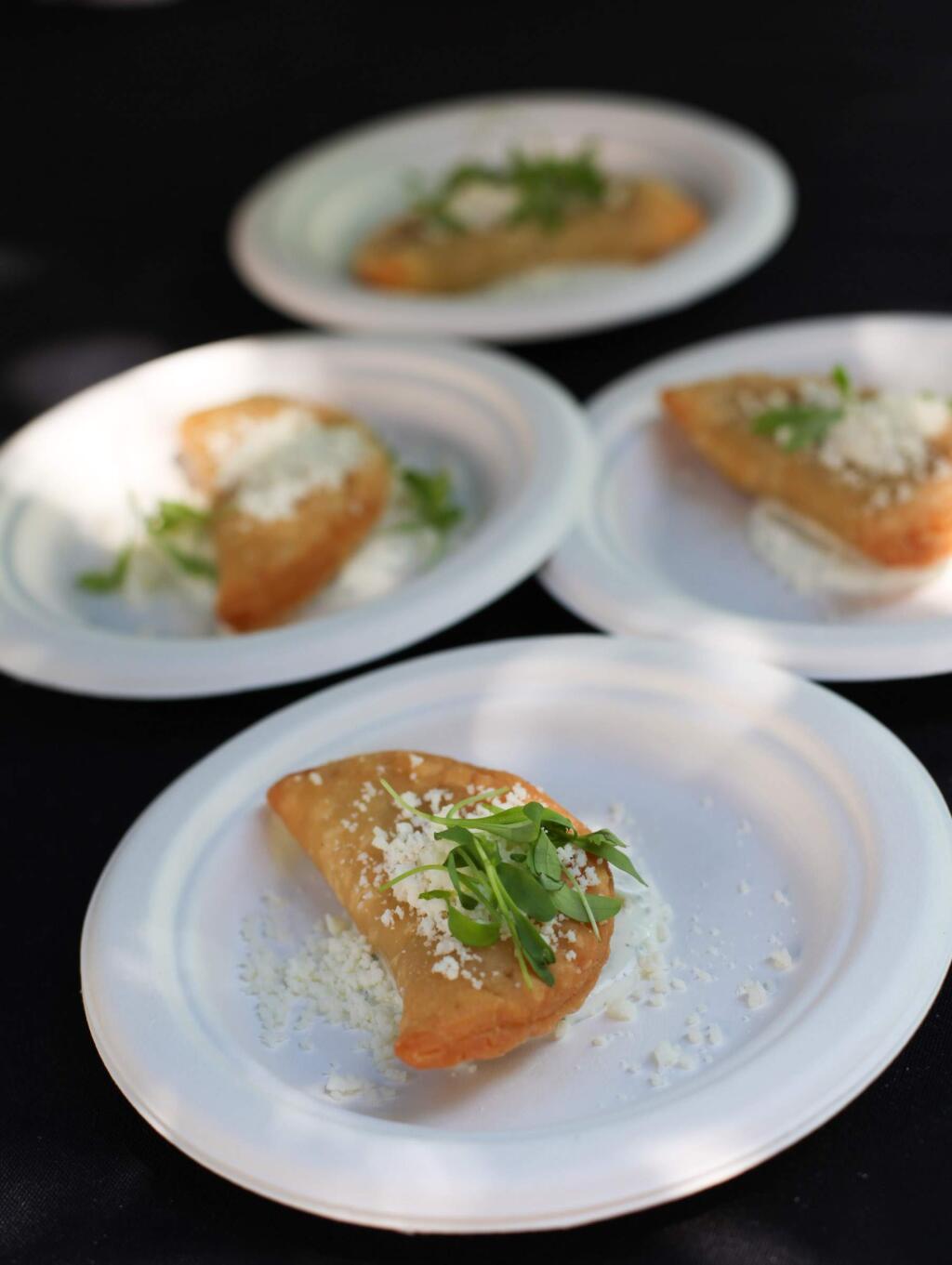 Speakeasy/Big Easy serves up 'Putnam Plaza' empanadas with Niman Ranch steak and potatoes topped with a lime cilantro crema, and crumbled queso fresco at A Taste of Petaluma benefiting Cinnabar Theater on Saturday August 23, 2014. (VICTORIA WEBB/FOR THE ARGUS-COURIER)