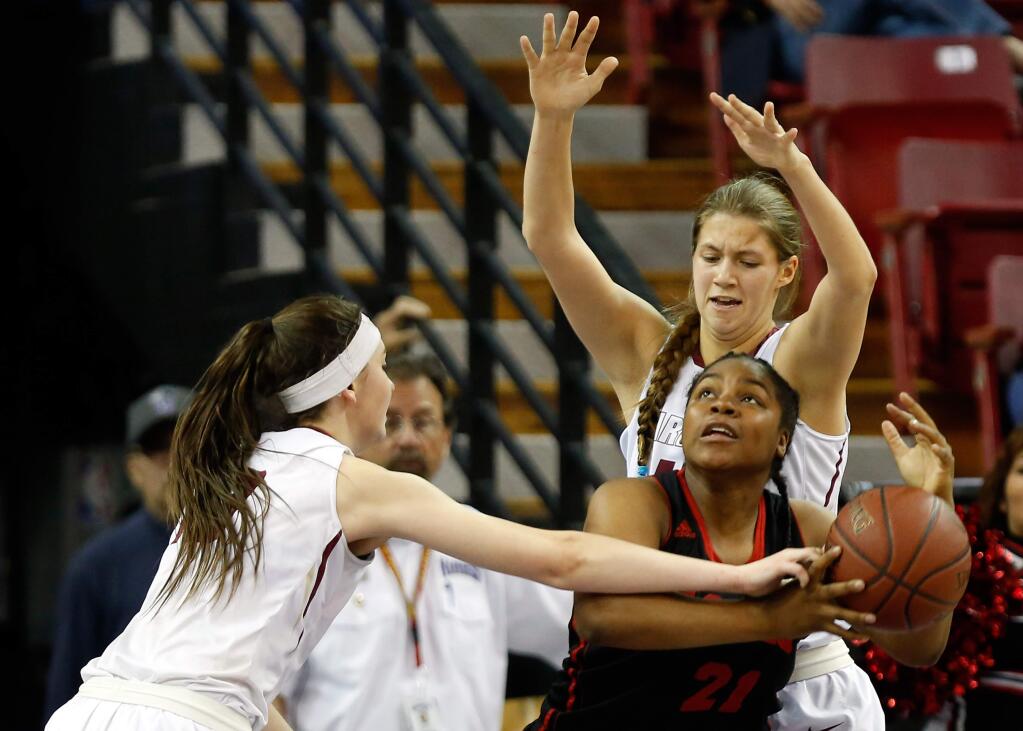 Cardinal Newman's Hailey Vice-Neat (13), left, and Lauren Walker (44) double-team Antelope Valley's Niyah Page (21) during the second half of the CIF Division IV girls basketball championship game between Cardinal Newman and Antelope Valley high schools at Sleep Train Arena in Sacramento, California, on Saturday, March 26, 2016. (Alvin Jornada / The Press Democrat)