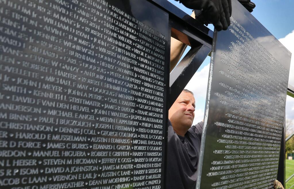 Mike Crean helps to assemble the Wall That Heals exhibit at Wilson Ranch Soccer Park in Windsor on Wednesday, March 27, 2019. (Christopher Chung/ The Press Democrat)