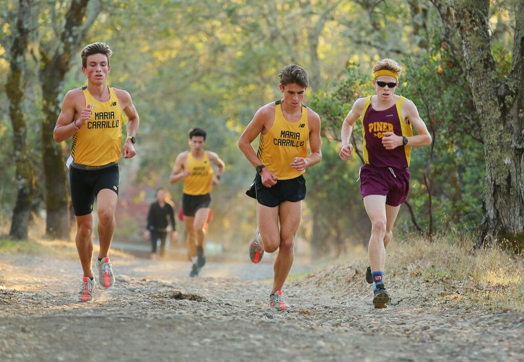 Maria Carrillo's Colton Swinth, left, and Rory Smail race against Piner's Nathan Hayes during their cross country meet at Foothill Regional Park in Windsor on Wednesday, Oct. 17, 2018. (Christopher Chung / The Press Democrat)