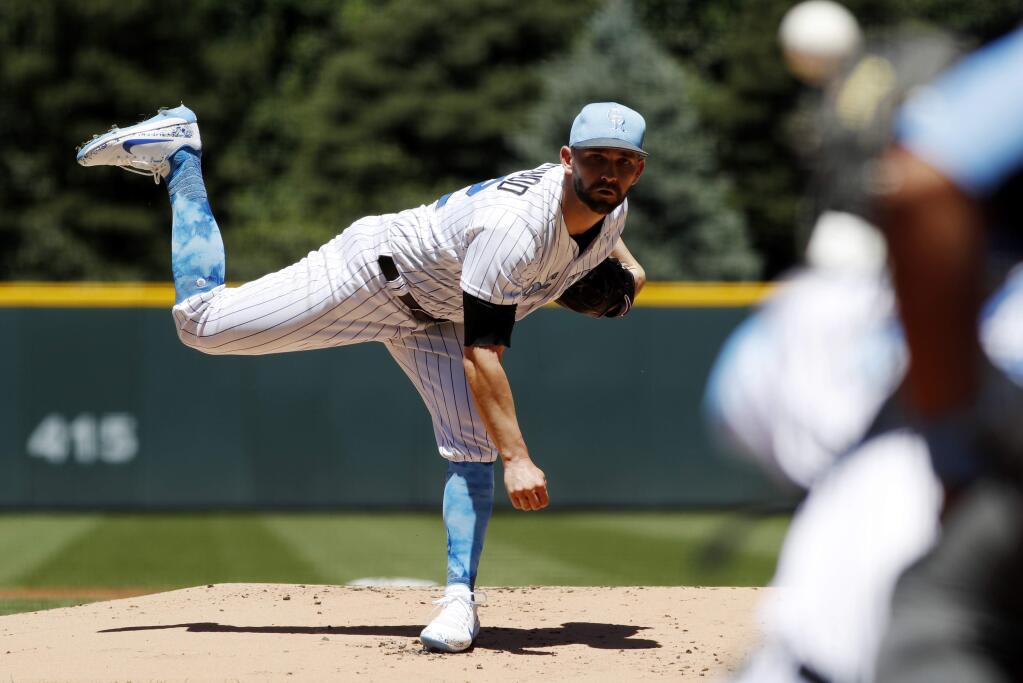 Colorado Rockies starting pitcher Tyler Chatwood delivers a pitch to San Francisco Giants' Joe Panik in the first inning of a baseball game, Sunday, June 18, 2017, in Denver. (AP Photo/David Zalubowski)