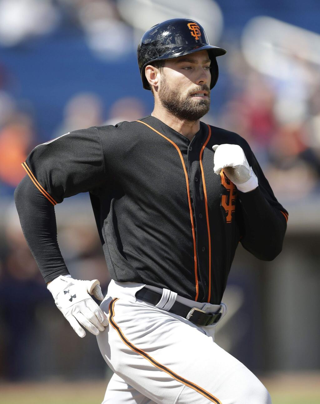 The San Francisco Giants' Mac Williamson runs to first during the second inning of a spring training game against the Milwaukee Brewers, Wednesday, Feb. 28, 2018, in Maryvale, Ariz. (AP Photo/Carlos Osorio)