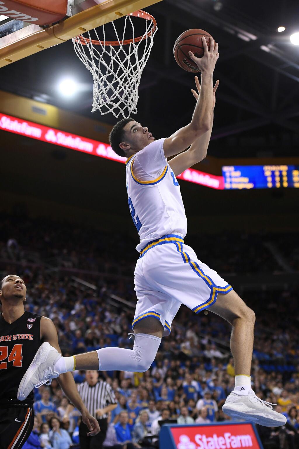 FILE - In this Feb. 12, 2017, file photo, UCLA guard Lonzo Ball, top, shoots as Oregon State guard Kendal Manuel, left, defends during the second half of an NCAA college basketball game, in Los Angeles. Ball was selected to The Associated Press NCAA college basketball men's All-America first team, Tuesday, March 28, 2017.(AP Photo/Mark J. Terrill, File)