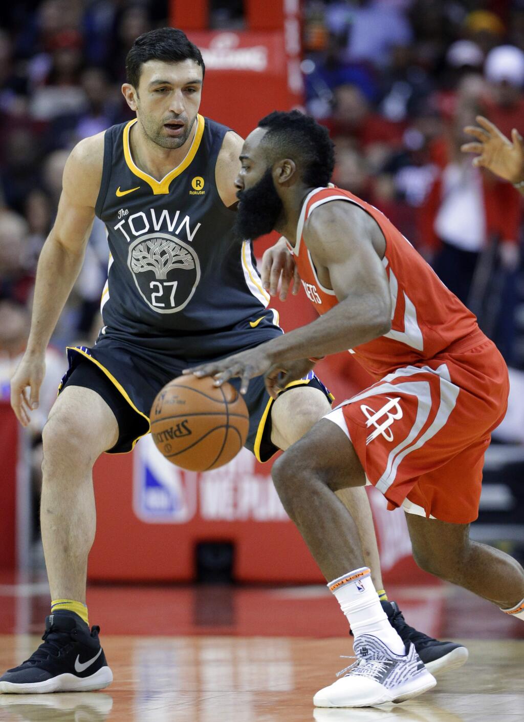 Houston Rockets guard James Harden (13) drives around Golden State Warriors center Zaza Pachulia (27) during the first half of an NBA basketball game Saturday, Jan. 20, 2018, in Houston. (AP Photo/Michael Wyke)