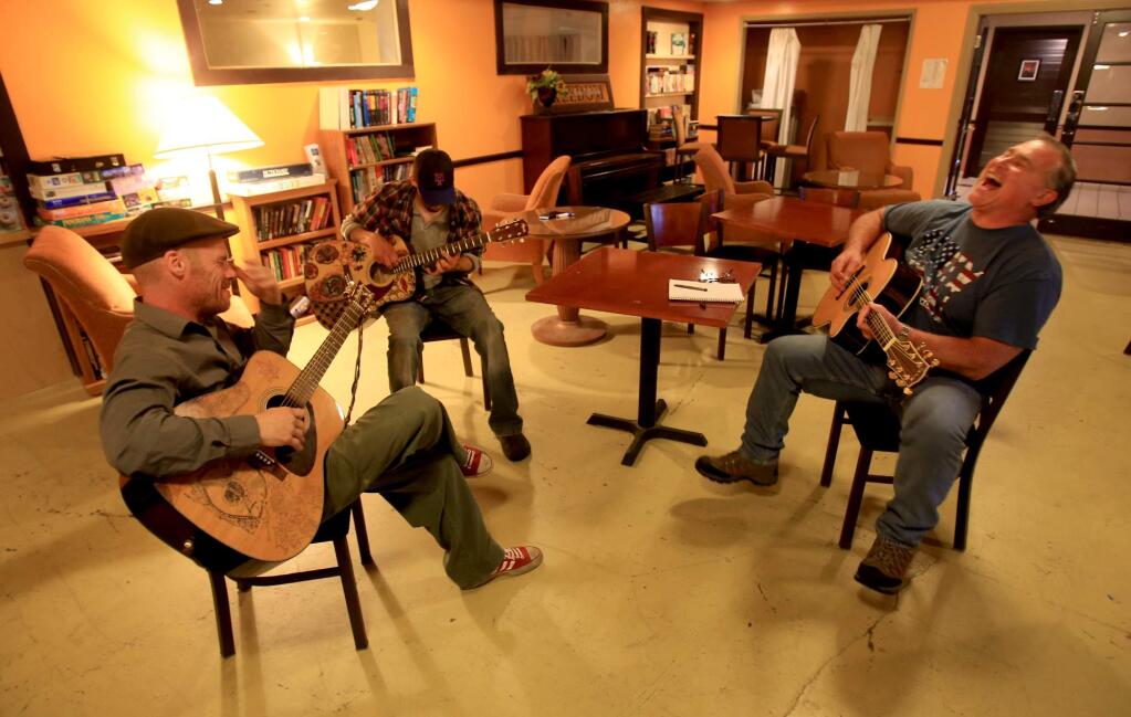 Tony Patton of Windsor, right, stopped by the Palms Inn on Santa Rosa Ave., Friday May 5, 2016 to jam with homeless vets Aaron Mello, left and Will Krauss, both residents of the Palms. All three of the men were in the Army. (Kent Porter / Press Democrat ) 2016
