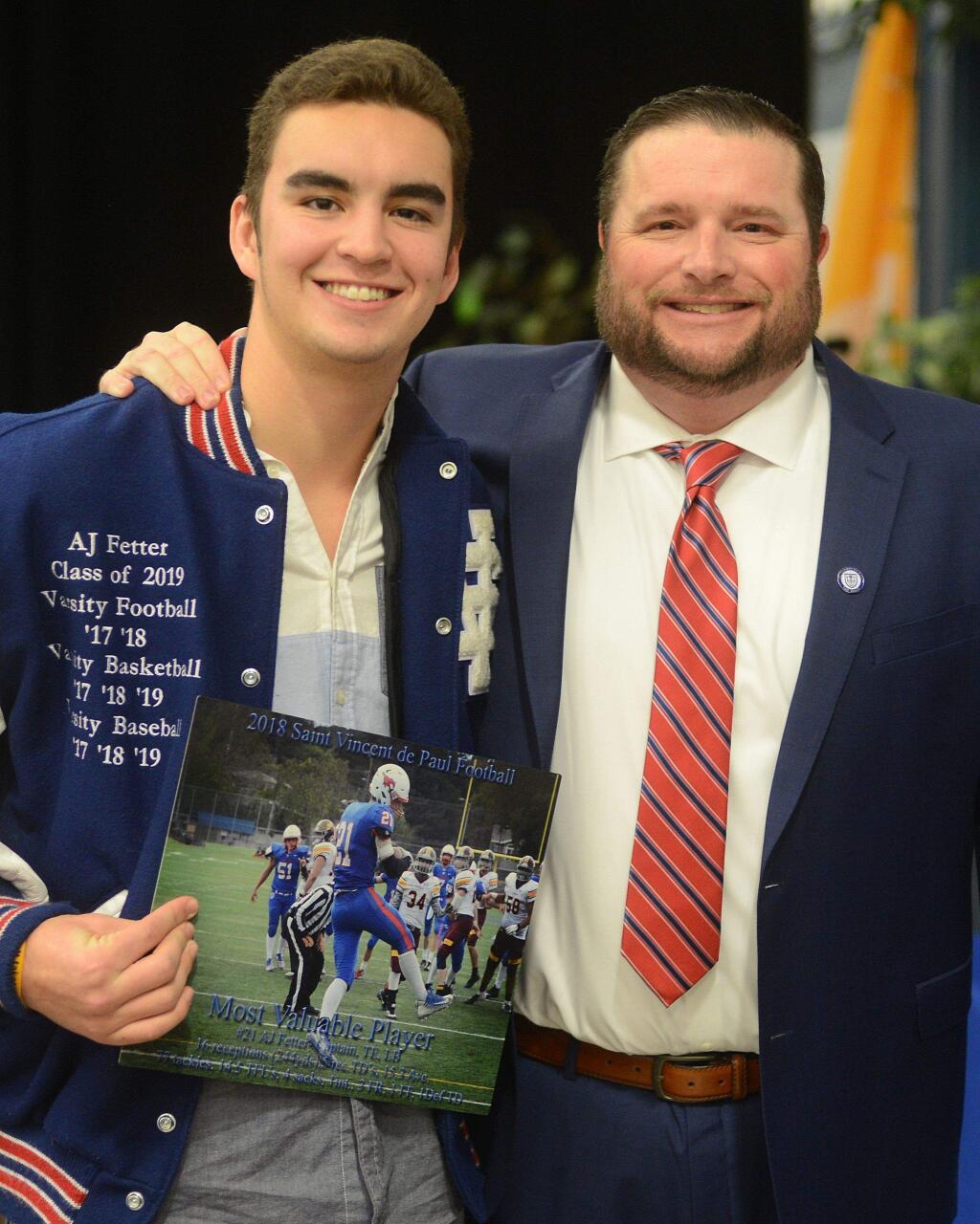 SUMNER FOWLER/FOR THE ARGUS-COURIERAJ Fetter, shown with St. Vincent football coach Trent Herzog, was chosen the Outstanding Defensive Player in the Tri-County All-Star football game. He also shared Most Valuable Player honors on his own Mustang team with Gio Antonini.