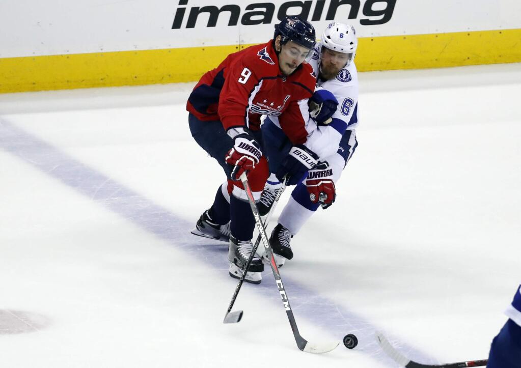 Washington Capitals defenseman Dmitry Orlov (9), from Russia, and Tampa Bay Lightning defenseman Anton Stralman (6), from Sweden, battle for the puck during the first period of Game 6 of the NHL Eastern Conference finals hockey playoff series Monday, May 21, 2018, in Washington. (AP Photo/Alex Brandon)