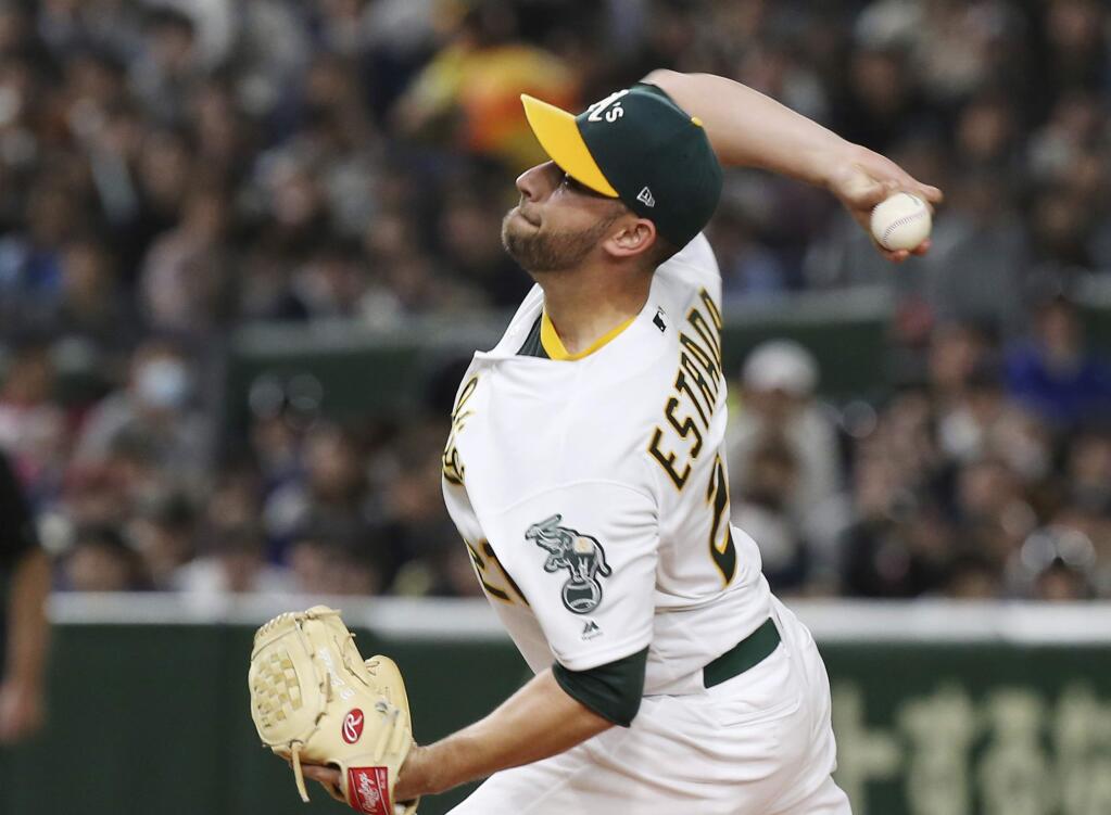 The Oakland Athletics starter Marco Estrada pitches against the Seattle Mariners in the first inning of Game 2 of their Major League Baseball opening series at Tokyo Dome in Tokyo, Thursday, March 21, 2019. (AP Photo/Koji Sasahara)