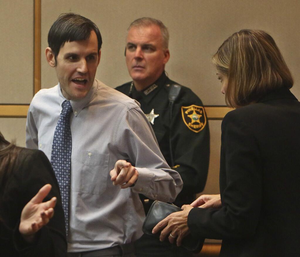 Defendant John Jonchuck, left, talks with his attorney Jane McNeill, right, during a break in his murder trial, Tuesday, April 2, 2019 at the Pinellas County Criminal Justice Center in Clearwater, Fla. Jonchuck is accused of killing his 5-year-old daughter by dropping her off a bridge (Scott Keeler/Tampa Bay Times via AP, Pool)
