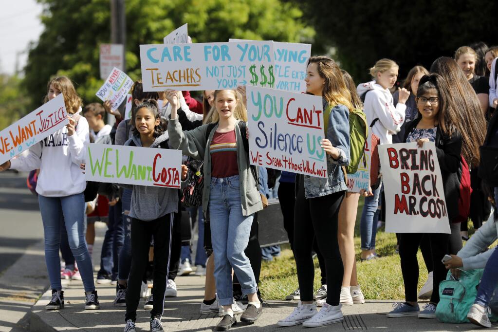 Healdsburg Junior High School students hold signs and yell chants as they stage a walkout to protest teacher layoffs. Photo taken in Healdsburg on Monday, May 13, 2019. (BETH SCHLANKER/ The Press Democrat)