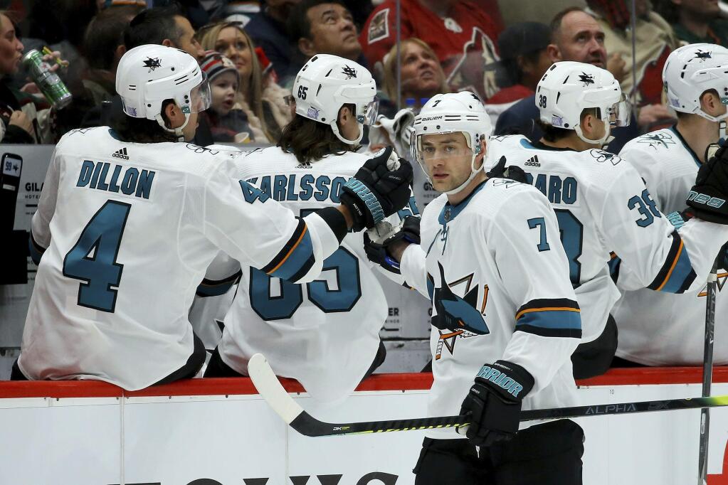 San Jose Sharks center Dylan Gambrell (7) celebrates his goal against the Arizona Coyotes with defenseman Brenden Dillon (4) and Erik Karlsson (65) during the second period Saturday, Nov. 30, 2019, in Glendale, Ariz. (AP Photo/Ross D. Franklin)