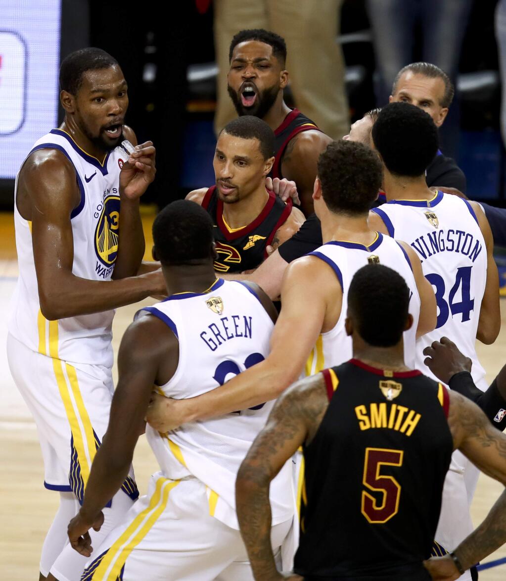 Cleveland Cavaliers center Tristan Thompson, top, yells at Golden State Warriors forward Draymond Green, bottom, during overtime of Game 1 of basketball's NBA Finals in Oakland, Calif., Thursday, May 31, 2018. The Warriors won 124-114. (AP Photo/Ben Margot)