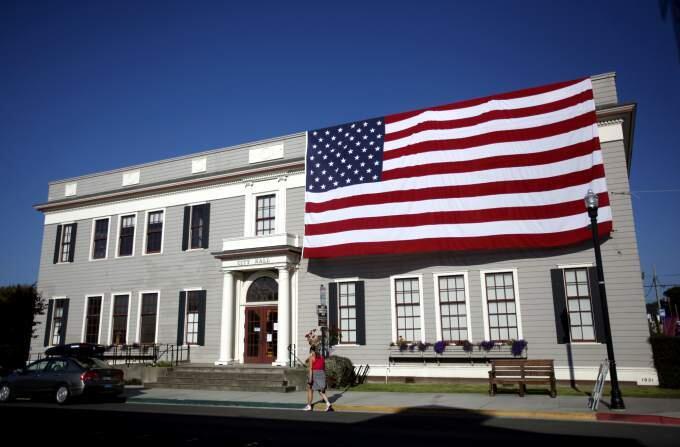 An American flag hangs on the City Hall building during Paul Bunyan Days held in Fort Bragg in 2011.