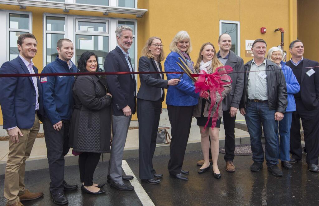 First District Supervisor Susan Gorin and Fetters Apartments resident Marisa Soulier led local notables and MidPen Housing representatives in cutting the ribbon to declare the development officially open, on Thursday, Jan. 18. (Robbi Pengelly/Index-Tribune)