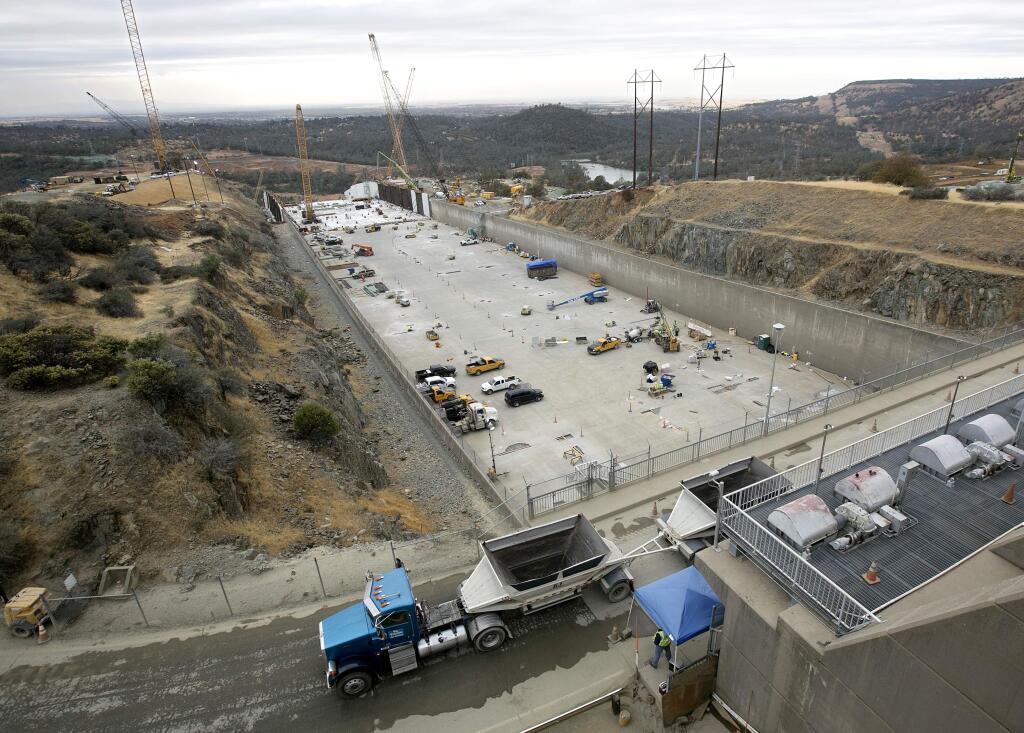 FILE -- In this Oct. 19, 2017 file photo crews work to repair the damaged main spillway of the Oroville Dam in Oroville, Calif. The Department of Water Resources announced Wednesday, Oct. 31, 2018 that it has met its Nov. 1 goal of completely reconstructing the dams main spillway in time for the upcoming winter. The main spillway and emergency spillway suffered significant damage during storms in February of 2017, prompting fears of massive flooding. (AP Photo/Rich Pedroncelli, file)