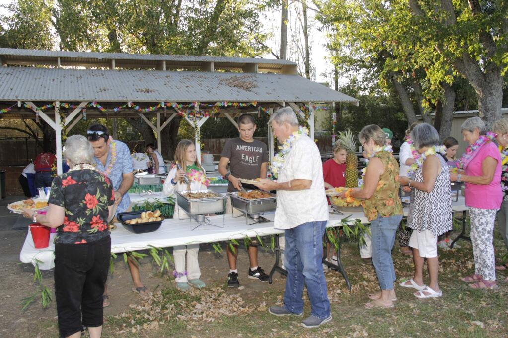 People lining up for a great Hawaiian dinner at the Penngrove Social Firemen's 6th annual Hawaiian Luau in Penngrove Park on Saturday, September 19, 2015. (Jim Johnson/For the Argus-Courier)