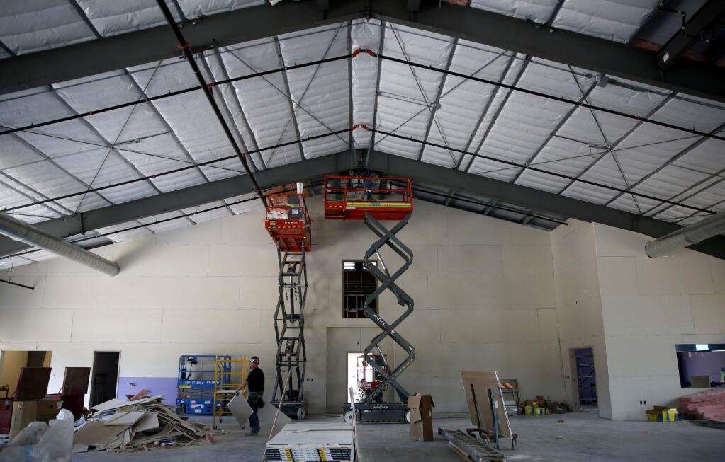 Workman install insulation inside to a new 12,000 sq. ft. agricultural facility under construction at the Sonoma County Fairgrounds in Santa Rosa, on Tuesday, June 14, 2016. (BETH SCHLANKER/ The Press Democrat)
