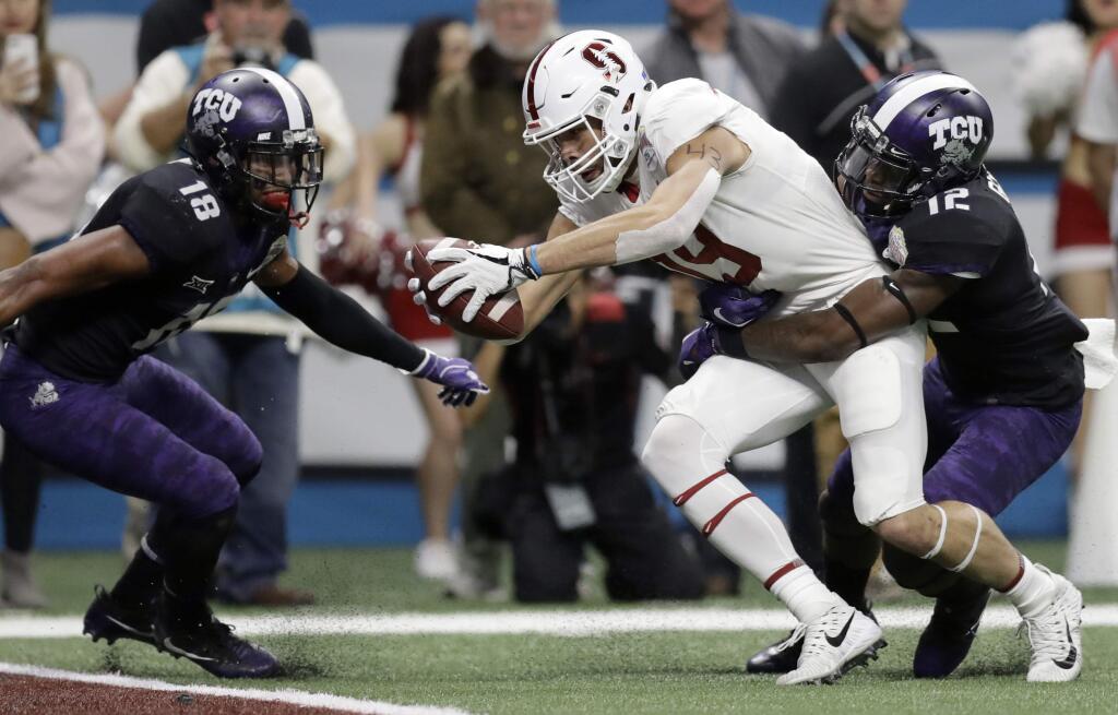 Stanford wide receiver J.J. Arcega-Whiteside (19) stretches out with a pass in front of TCU cornerback Jeff Gladney (12) for a touchdown during the first half of the Alamo Bowl NCAA college football game, Thursday, Dec. 28, 2017, in San Antonio. (AP Photo/Eric Gay)