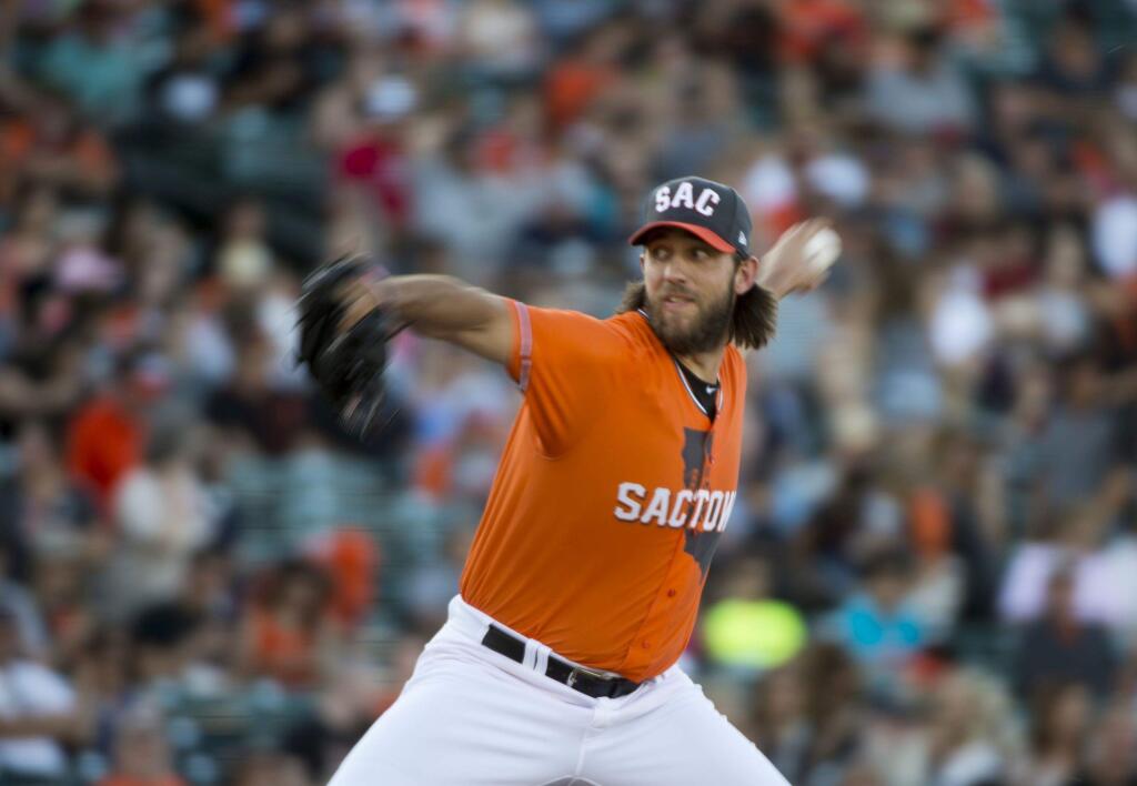 San Francisco Giants' Madison Bumgarner pitches in his first rehab assignment with the Sacramento River Cats as they host the Fresno Grizzlies in a baseball game Friday, June 30, 2017, in West Sacramento, Calif. (Jose Luis Villegas/The Sacramento Bee via AP)