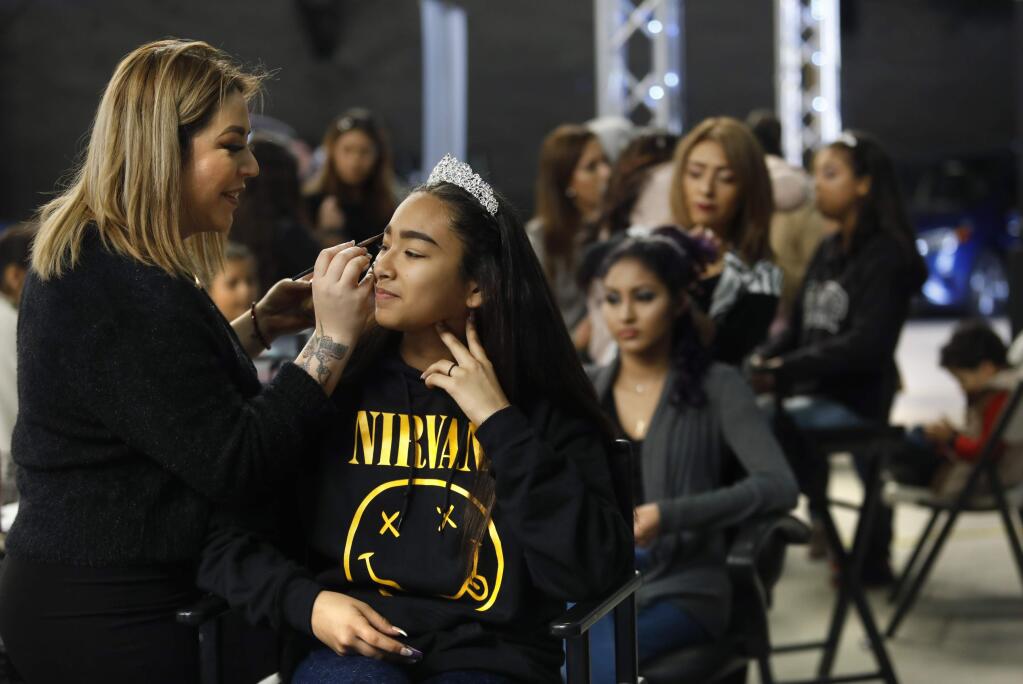 Michelle Walter, 15, gets her makeup done by Monica Franco of Franco's Beauty Salon during the Quince y Novias Expo at the Hall of Flowers at the Sonoma County Fairgrounds Sunday, March 11, 2018 in Santa Rosa, California. (BETH SCHLANKER/The Press Democrat)