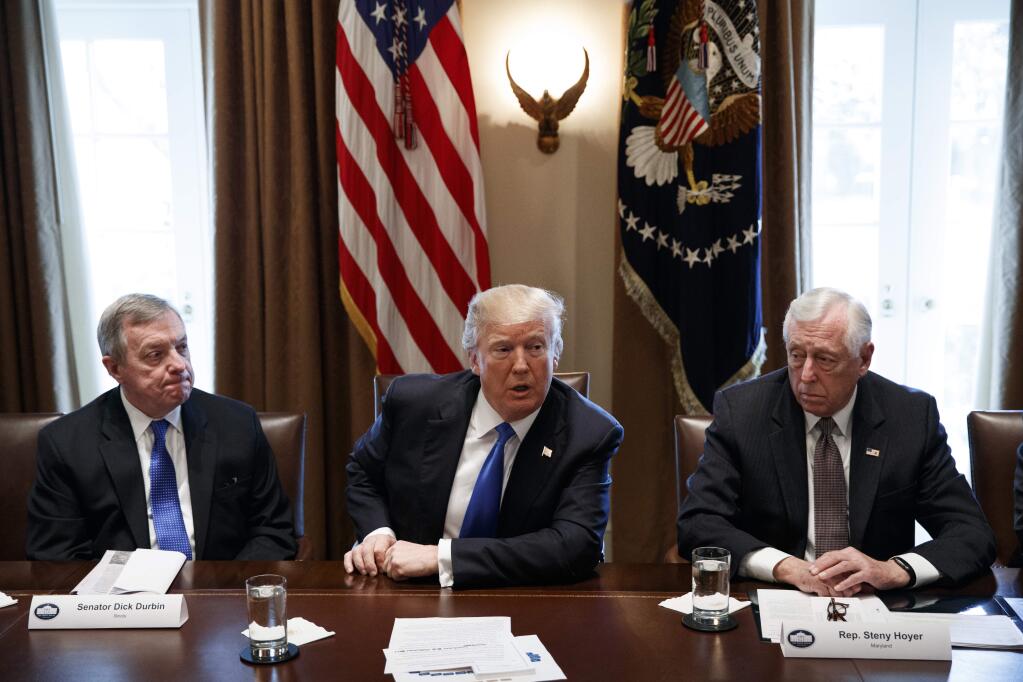 In this Jan. 9, 2018, photo, Sen. Dick Durbin, D-Ill., left, and Rep. Steny Hoyer, D-Md. listen as President Donald Trump speaks during a meeting with lawmakers on immigration policy in the Cabinet Room of the White House in Washington. Bargainers seeking a bipartisan immigration accord planned talks as soon as Wednesday as President Donald Trump and leading lawmakers sought to parlay an extraordinary White House meeting into momentum for resolving a politically blistering issue. (AP Photo/Evan Vucci)