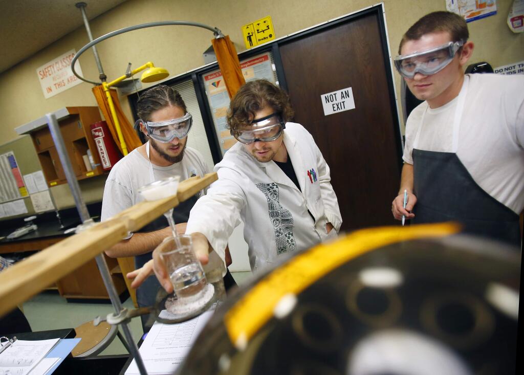 Chemistry professor Robert Guinn, center, helps his students John Laxton, left, and Kyle Lowery, right, complete their work in the labs at Bech Hall at SRJC on Friday, September 5, 2014. The aging building complex is in need of updates, especially the labs. (Conner Jay/The Press Democrat)