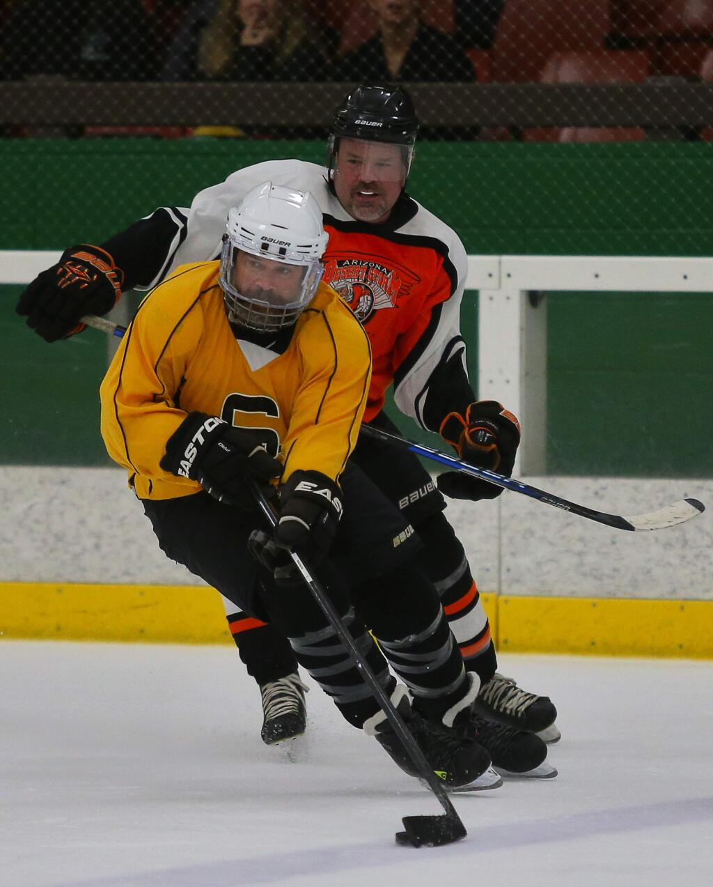 The Bruins' Michael Preiss, foreground, skates away from Arinzona Desert Storm's Mark Atha during Snoopy's Senior World Hockey Tournament at the Redwood Empire Ice Arena in Santa Rosa on Friday, July 21, 2017. (Christopher Chung/ The Press Democrat)
