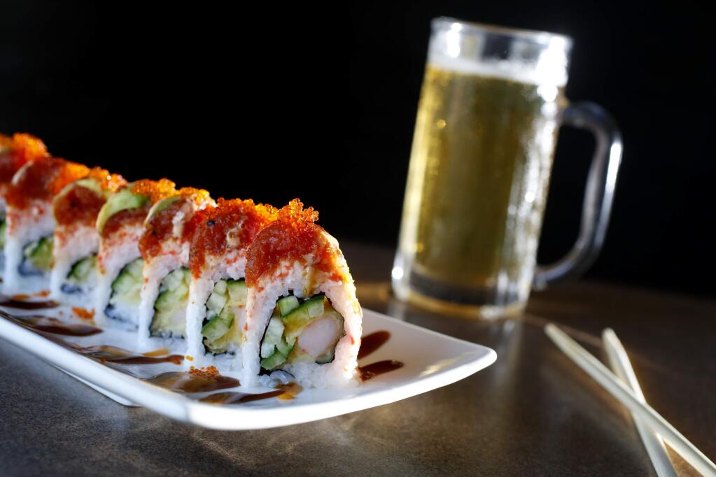 A Red Dragon Roll and a Sapporo beer at O! Sushi, on Monday, June 8, 2015. (BETH SCHLANKER/ The Press Democrat)