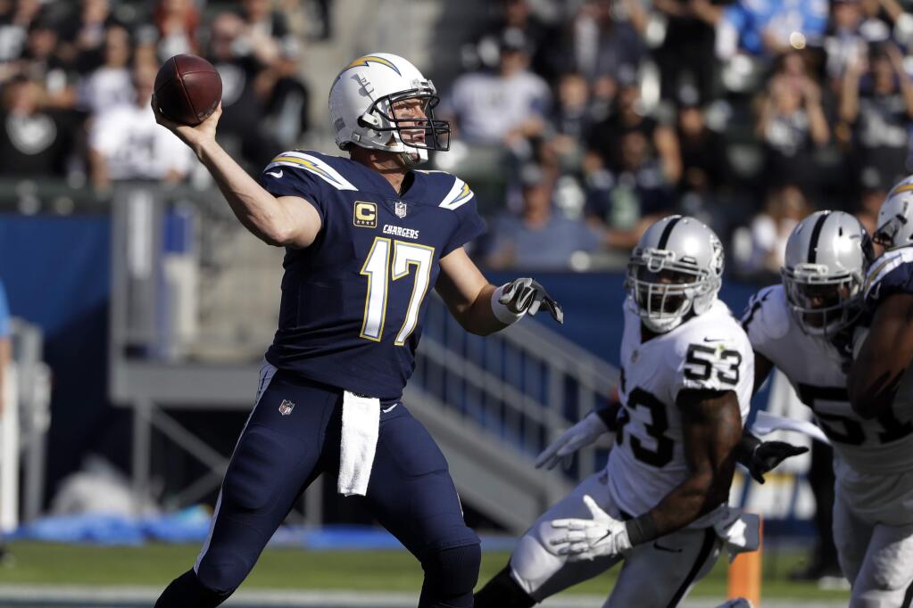 Los Angeles Chargers quarterback Philip Rivers throws a pass during the first half of an NFL football game against the Oakland Raiders, Sunday, Dec. 31, 2017, in Carson, Calif. (AP Photo/Alex Gallardo)