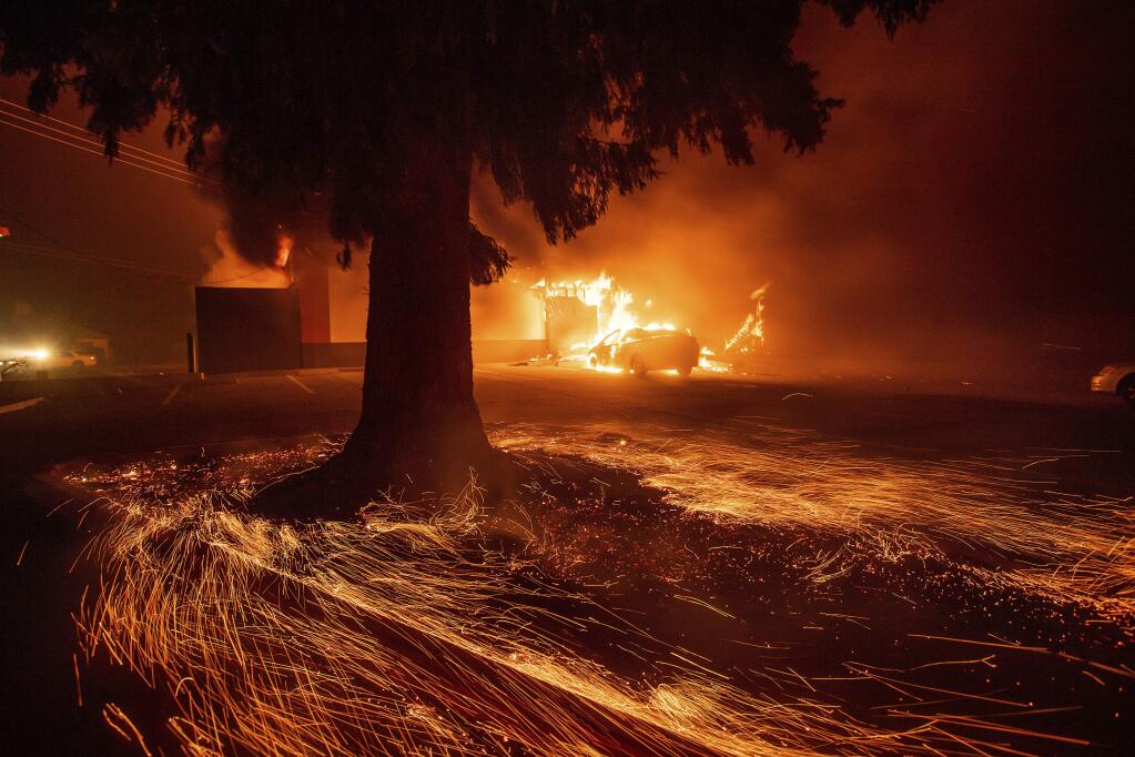 Flames consume a Kentucky Fried Chicken as the Camp Fire tears through Paradise, Calif., on Thursday, Nov. 8, 2018. Tens of thousands of people fled a fast-moving wildfire Thursday in Northern California, some clutching babies and pets as they abandoned vehicles and struck out on foot ahead of the flames that forced the evacuation of an entire town and destroyed hundreds of structures. (AP Photo/Noah Berger)
