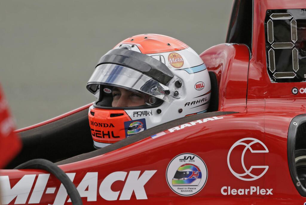 Graham Rahal waits in his car for the start of practice for the IndyCar auto race Saturday, Aug. 29, 2015, in Sonoma, Calif. Stickers on Rahal's car and helmet pay tribute to Justin Wilson, of Great Britain, who died Aug. 24 from injuries sustained at Pocono Raceway. (AP Photo/Eric Risberg)