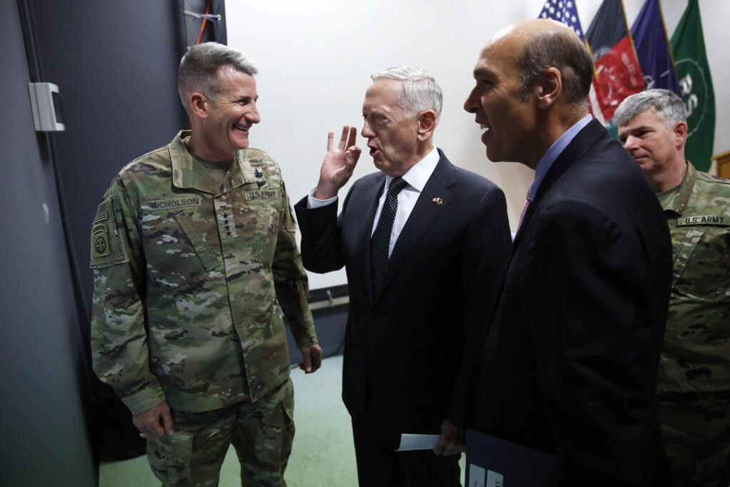 U.S. Defense Secretary James Mattis, center, chats with U.S. Army General John Nicholson, left, commander of U.S. Forces Afghanistan, after a news conference at Resolute Support headquarters in Kabul, Afghanistan, Monday, April 24, 2017. Mattis arrived unannounced in Afghanistan to assess America's longest war as the Trump administration weighs sending more U.S. troops. (Jonathan Ernst/Pool Photo via AP)