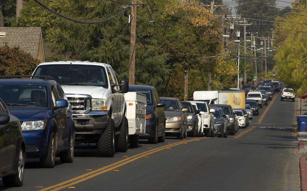 Cars move slowly down University Street in Healdsburg Saturday at noon after officials ordered the evacuation of the town in anticipation of the Kincade fire moving southwest with heavy winds Saturday night. (John Burgess/The Press Democrat)