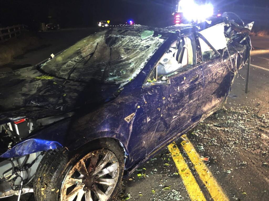 This photo provided by NBC Bay Area-KNTV shows a Tesla car after it was pulled from a pond near the city of San Ramon, Calif., on Monday, May 21, 2018. Authorities in the San Francisco Bay Area are investigating the death of a man after the Tesla car he was driving veered off a road, crashed through a fence and into a pond. (Bob Rendell/NBC Bay Area/KNTV via AP)