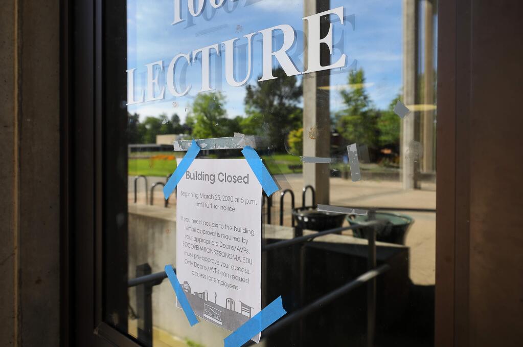 A closed sign is posted on the door of a large lecture room at Stevenson Hall on the Sonoma State University campus, in Rohnert Park on Monday, April 27, 2020. (Christopher Chung/ The Press Democrat)